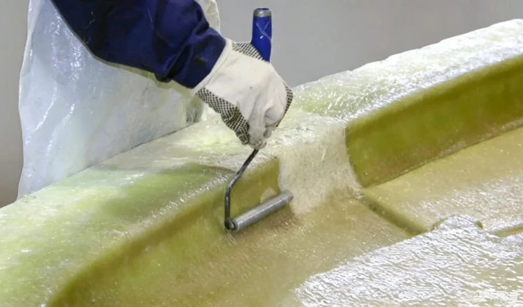 Resin is coated onto the fiberglass mat