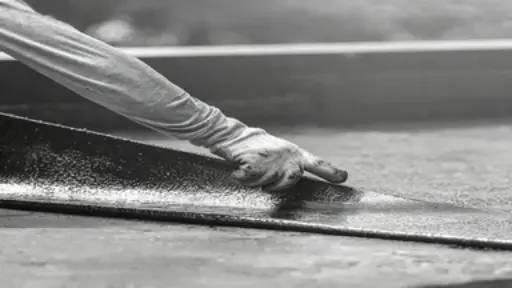 Industrial roofing waterproofing installation using high-tensile fiber mat reinforcement.