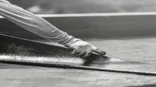 Industrial roofing waterproofing installation using high-tensile fiber mat reinforcement.